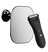Black electric hair trimmer positioned next to a rectangular wall-mounted mirror.